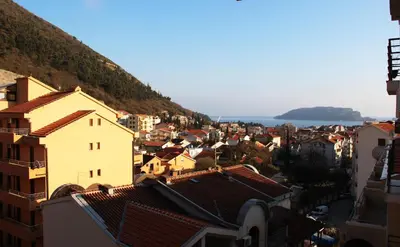 a view of a city with buildings and the ocean at Apartman Nina in Budva