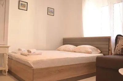 a bedroom with a bed with two pillows on it at Old Town Experience - Studio Apartment in Budva