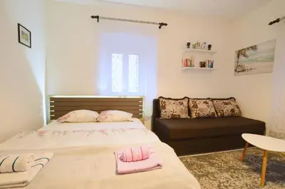 a bedroom with a bed and a couch at Old Town Experience - Studio Apartment in Budva