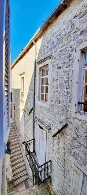 a brick building with a bench in front of it at Old Town Experience - Studio Apartment in Budva