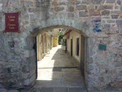 an alley with an archway in a stone building at Old Town Experience - Studio Apartment in Budva