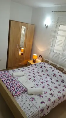 a bedroom with a large bed with flowers on it at Apartments Sirena in Ulcinj