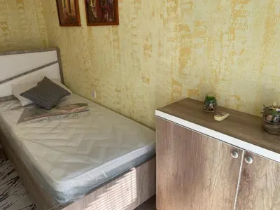 a small bedroom with a bed and a counter at Apartmani Miljana in Bar