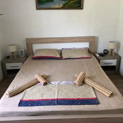 a bed with three wooden baseball bats on it at Apartmani Miljana in Bar