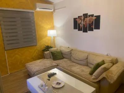 a living room with a couch and a coffee table at Apartmani Miljana in Bar