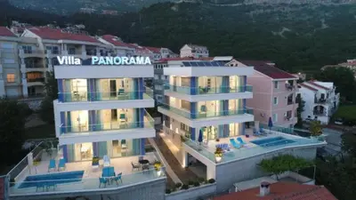 a large white building with a sign on it at Villa Blue Panorama in Budva