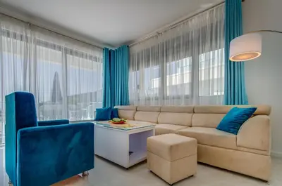 a living room with blue curtains and a couch at Villa Blue Panorama in Budva