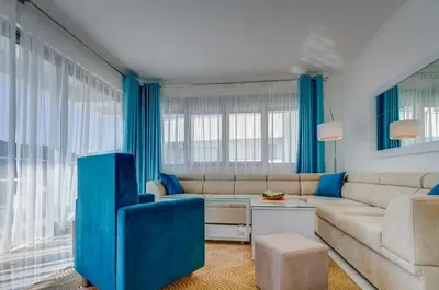 a living room with blue curtains and a couch at Villa Blue Panorama in Budva