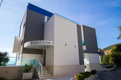 a large white building with a sign on it at Villa Blue Panorama in Budva