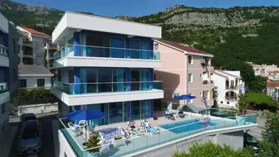 a house with a balcony with a swimming pool at Villa Blue Panorama in Budva