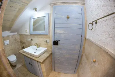 a bathroom with a sink and a toilet and a door at Medin Apartments BluVista in Petrovac na Moru