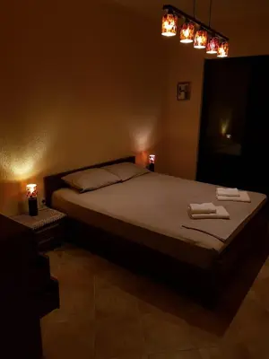 a bedroom with a bed with two towels on it at Villa 
