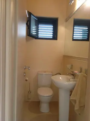 a bathroom with a toilet and a sink at Villa 
