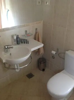 a bathroom with a sink and a toilet at Villa 