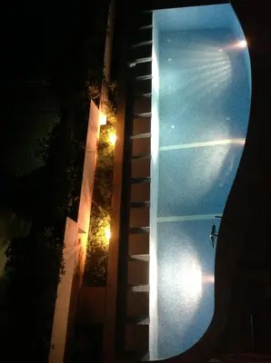 a view of a swimming pool at night at Villa 