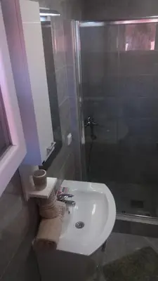 a bathroom with a sink and a shower at Apartments Maljevic in Bar