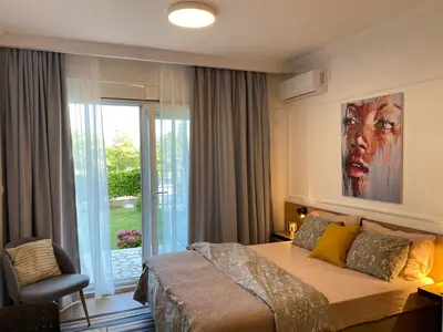 a bedroom with a bed with a large painting on the wall at VilaA21 in Bar