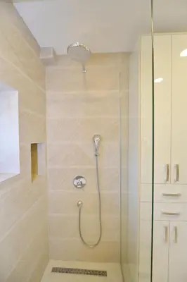 a shower with a shower head in a bathroom at Apartments PROVA in Sveti Stefan