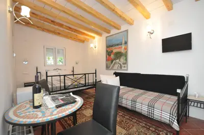a living room with a bed and a table at Hotel Oaza in Budva