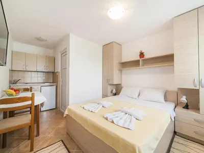 a bedroom with a bed with towels on it at Hana Accommodation in Sveti Stefan