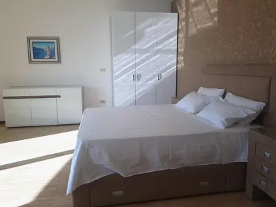 a bedroom with a large bed with white sheets and pillows at Apartmani Svetionik in Budva