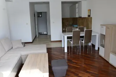 a living room with a couch and a table with chairs at Apartmani Svetionik in Budva