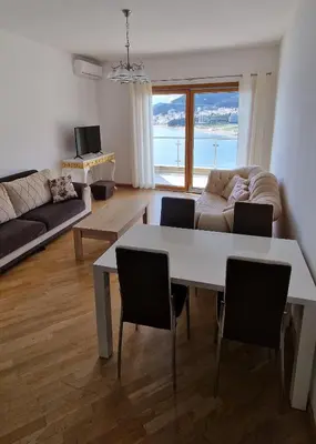 a living room with a white table and chairs at Apartmani Svetionik in Budva