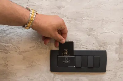 a hand is pushing a button on a electronic device at Hotel Admiral in Budva