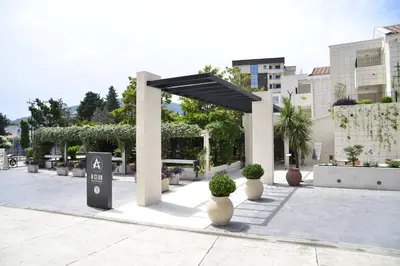 a pavilion with potted plants and a parking sign at Hotel Admiral in Budva