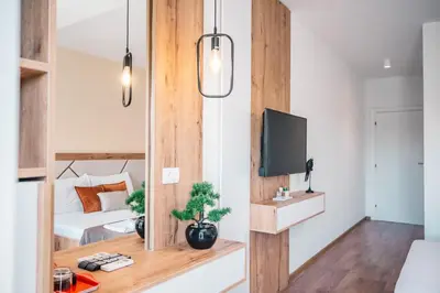 a bedroom with a bed and a tv in a room at Apartments Cungu in Ulcinj