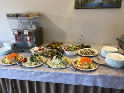 a table with a bunch of plates of food on it at Apartments Cungu in Ulcinj