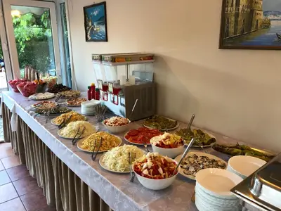 a buffet with many plates of food on a table at Apartments Cungu in Ulcinj
