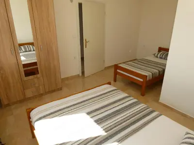 a small room with two beds and a mirror at Apartments In Amor in Ulcinj