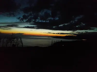 a sunset over a body of water with the sky at Holiday House Stari Volat in Budva