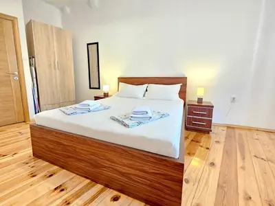 a bedroom with a bed with two towels on it at Apartments Kaleta in Kotor