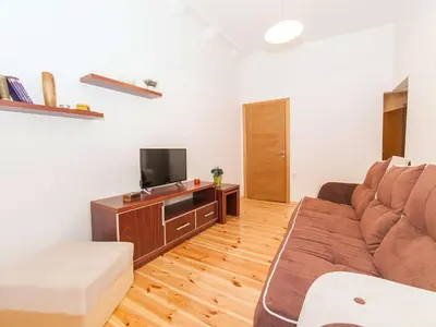 a living room with a couch and a tv at Apartments Kaleta in Kotor