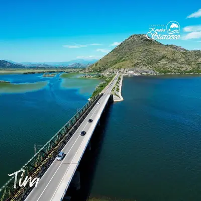 a bridge over a body of water with cars on it at Apartmani Konoba Starčevo in Virpazar