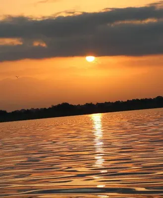 a sunset over a large body of water at Apartmani Konoba Starčevo in Virpazar