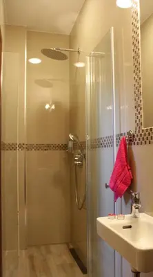 a bathroom with a glass shower and a sink at Filipa Apartment in Kotor