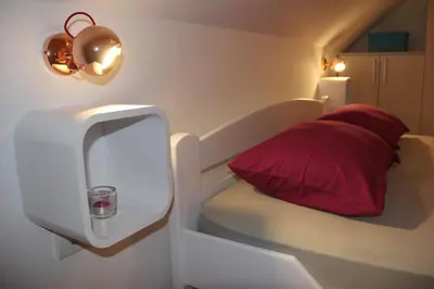 a bed with a red pillow in a room at Filipa Apartment in Kotor