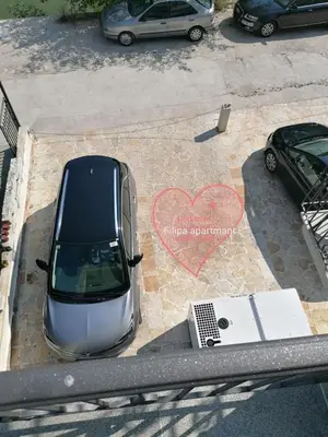 an overhead view of a car parked in a parking lot at Filipa Apartment in Kotor