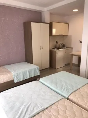 a room with two beds and a kitchen with a kitchen at Vip Apartmani Canj in Čanj