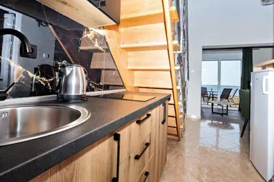 a kitchen with a sink and a counter top at Apartments Posejdon in Utjeha