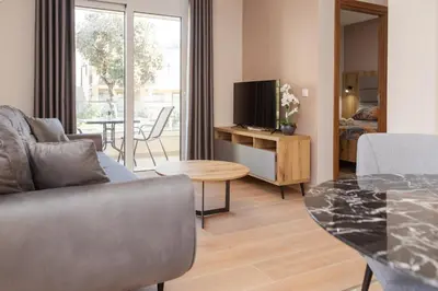 a living room with a couch and a table at Apartments Posejdon in Utjeha