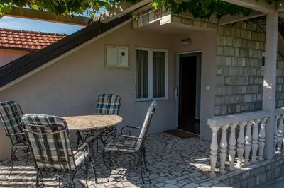 a table and chairs sitting on a patio at Apartmani Mendula in Budva