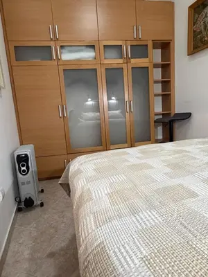 a bedroom with a bed and a wooden cabinet at Old town Kotor Square in Kotor