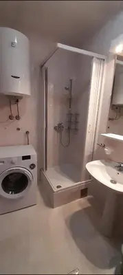 a bathroom with a shower and a washing machine at Old town Kotor Square in Kotor