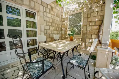 a table and chairs sitting on a patio at Apartments Captain's Villa in Budva