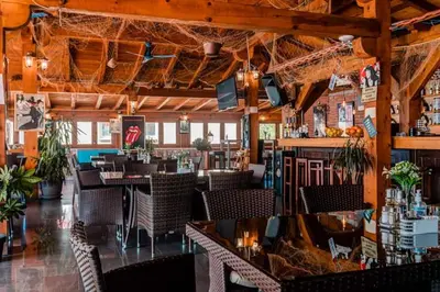 a restaurant with tables and chairs and a bar at Apartments Horizont in Budva