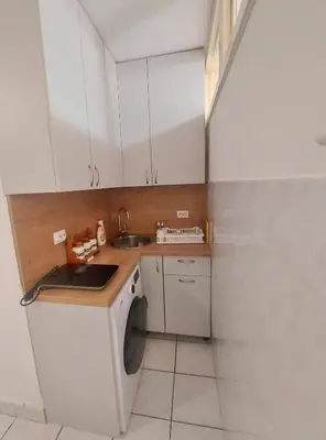 a kitchen with a washing machine and a sink at Apartment Oleander in Budva
